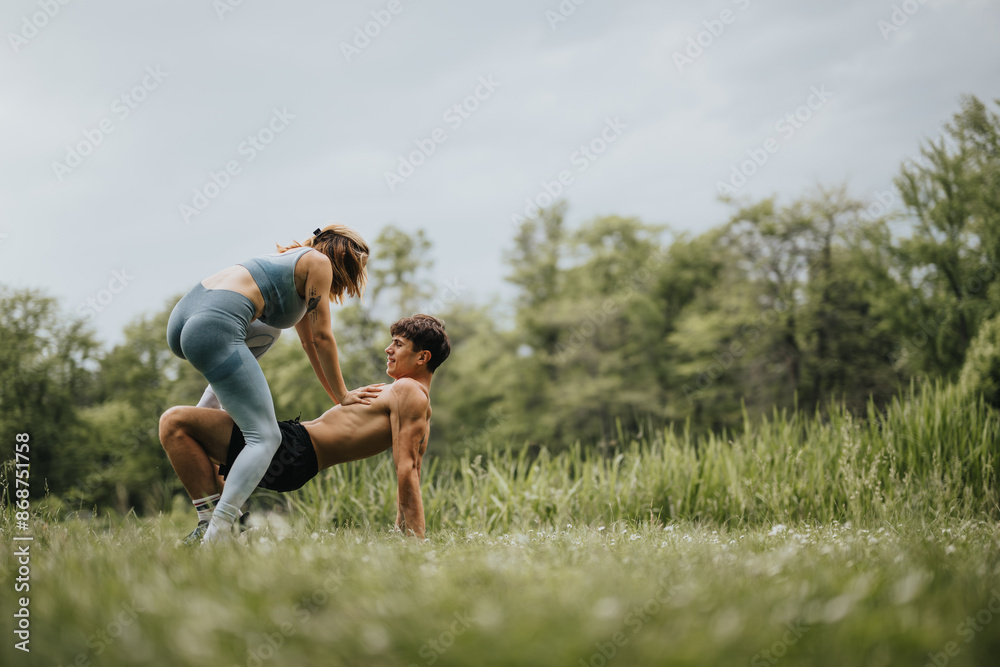 A couple practicing yoga in a scenic park, demonstrating balance and strength on a bright, sunny day. A couple practicing yoga in a scenic park, demonstrating balance and strength on a bright, sunny day.