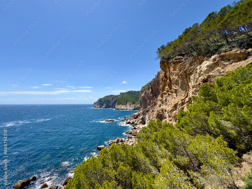 Fototapeta premium rocky coastline with cliff at the Costa Brava at the Mediterranean Sea between Sa Tuna and Fornells seen from the hiking trail Camí de Ronda near Begur, Catalonia, Costa Brava, Girona, Spain