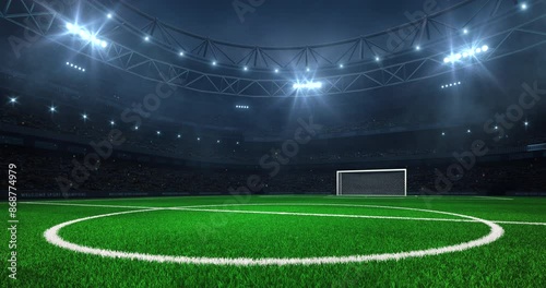 Modern sport stadium at night and football or soccer field with white goalpost ready for the match. Sports background as 4K video loop for advertising.