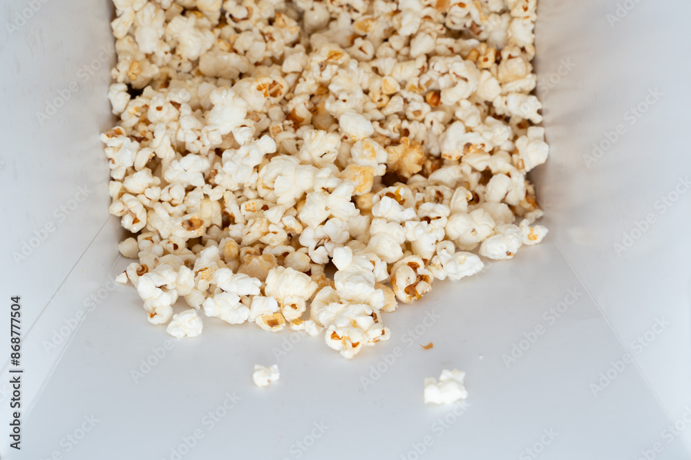 Sweet Popcorn Delight. A close-up view inside a white popcorn bucket filled with sweet, crispy popcorn Sweet Popcorn Delight. A close-up view inside a white popcorn bucket filled with sweet, crispy popcorn