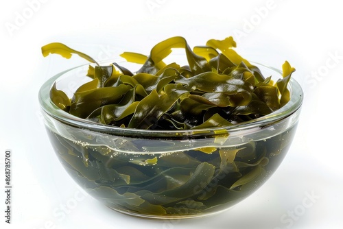 Laminaria seaweed in glass bowl close up white background photo