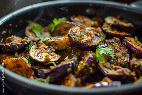 Make Indian crispy brinjal recipe by pan frying with selective focus photo