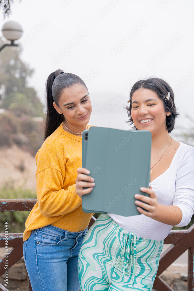 Happy tourists taking a selfie with digital tablet from viewpoint Happy tourists taking a selfie with digital tablet from viewpoint