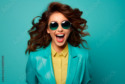 Vibrant woman in stylish sunglasses and a colorful outfit, laughing joyfully against a matching turquoise background. Perfect for themes of fashion, happiness, and modern lifestyle. Generative Ai. © Lucas