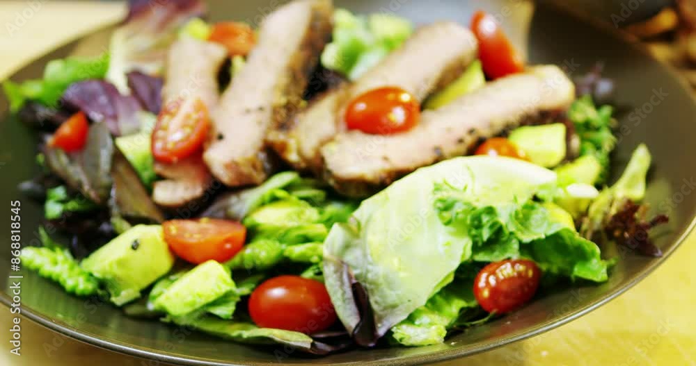 Adding salad dressing to red romaine steak salad Adding salad dressing to red romaine steak salad