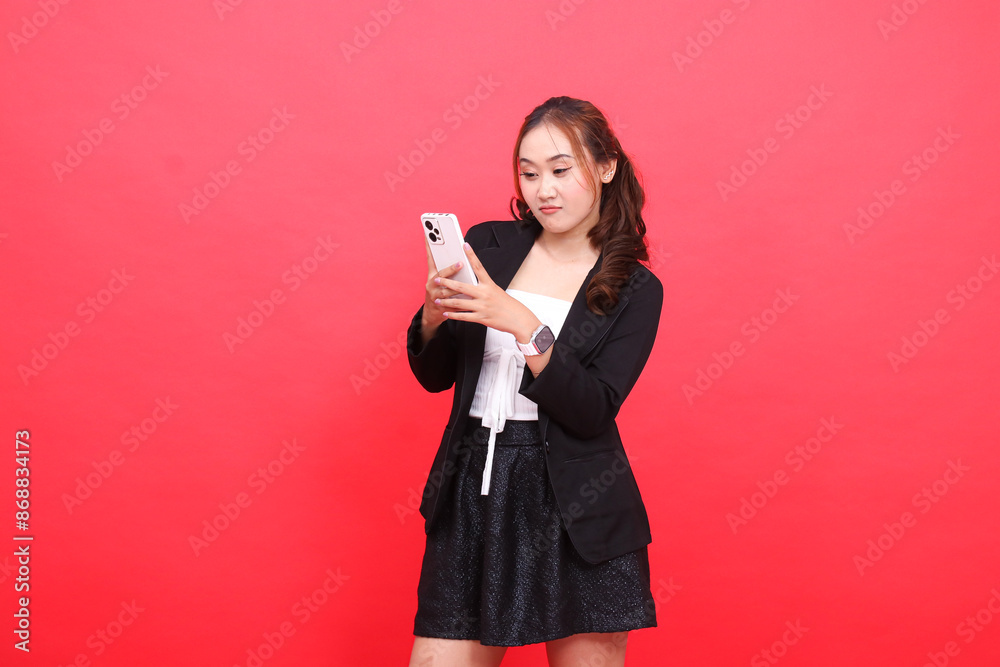 gesture of young asian career woman frowning wearing black formal suit hand operating smartphone cellphone, for technology content, business, advertising, finance gesture of young asian career woman frowning wearing black formal suit hand operating smartphone cellphone, for technology content, business, advertising, finance