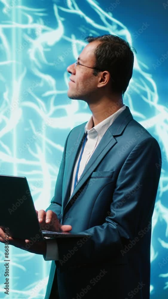 Vertical video Computer scientist using laptop to implement artificial ...