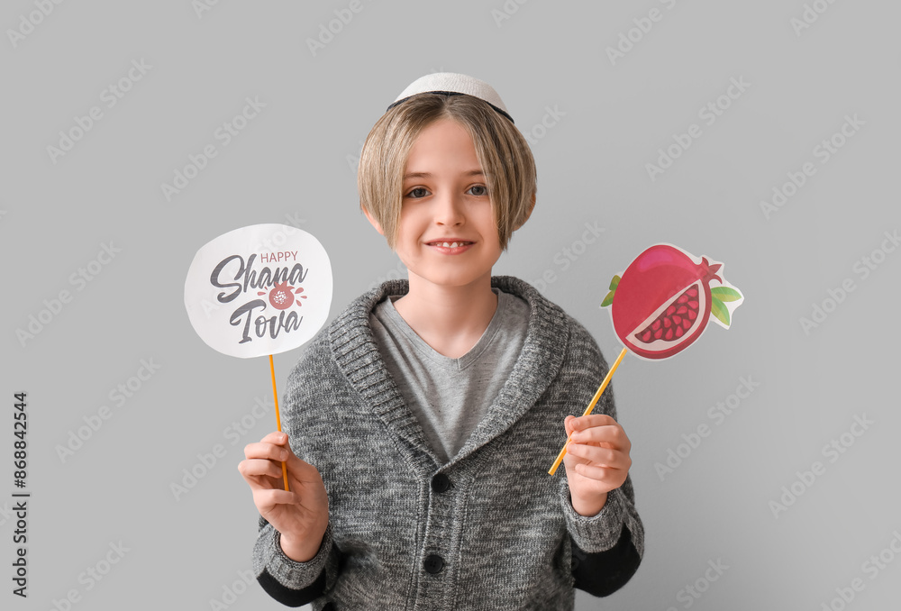 Cute little boy with decor for Rosh Hashanah (Jewish New Year) on grey background Cute little boy with decor for Rosh Hashanah (Jewish New Year) on grey background