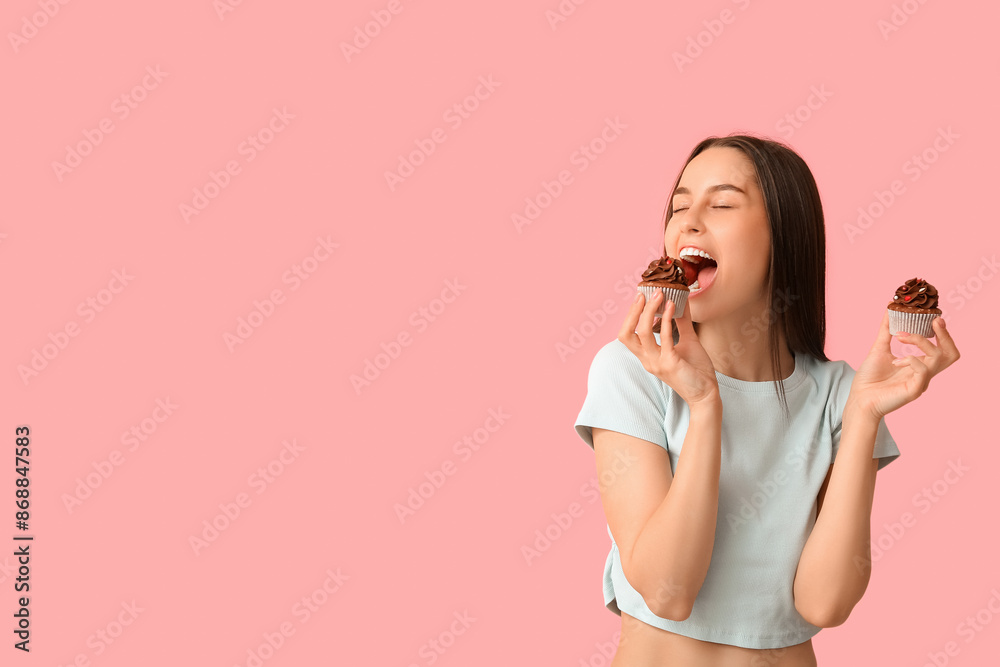 Young woman with sweet cupcakes on pink background. Valentine's Day celebration Young woman with sweet cupcakes on pink background. Valentine's Day celebration
