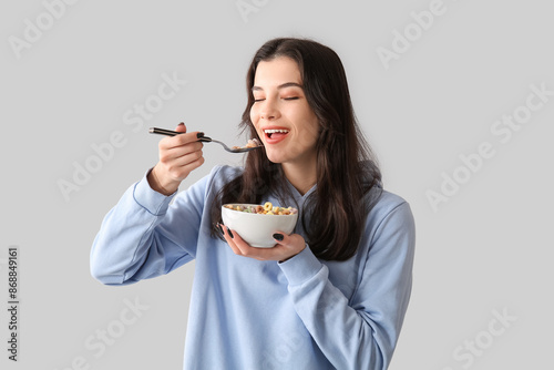 Young woman eating tasty ce...