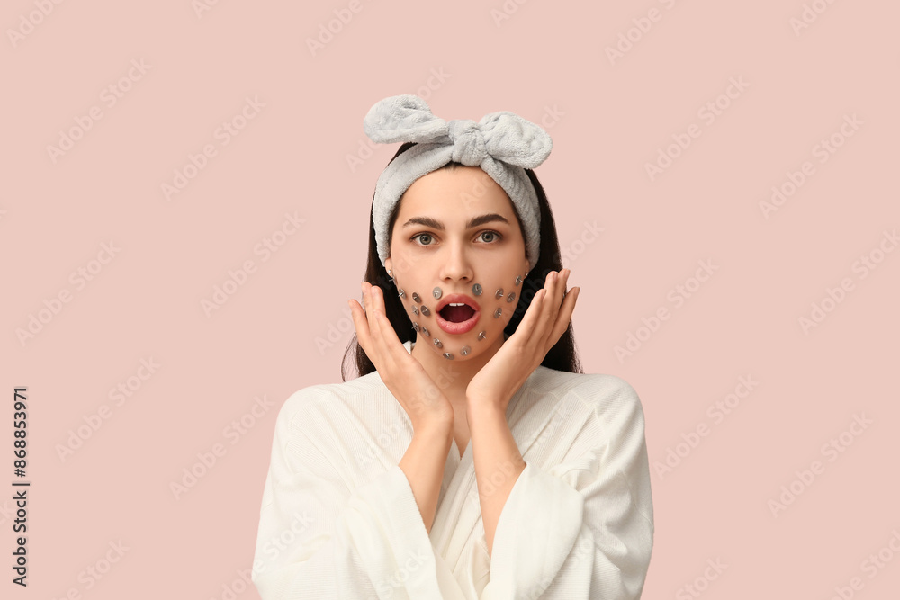 Beautiful young shocked woman with drawing pins on pink background. Depilation concept Beautiful young shocked woman with drawing pins on pink background. Depilation concept