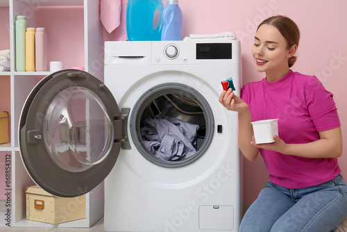 Young woman putting capsule...