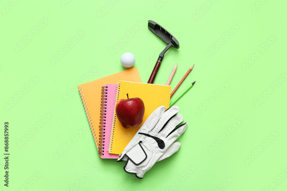 Composition with stationery, golf club,ball and glove on green background Composition with stationery, golf club,ball and glove on green background