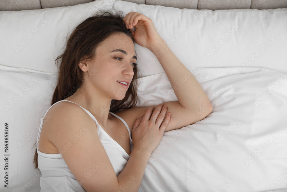 Bedtime. Beautiful woman lying on bed in morning, top view Bedtime. Beautiful woman lying on bed in morning, top view