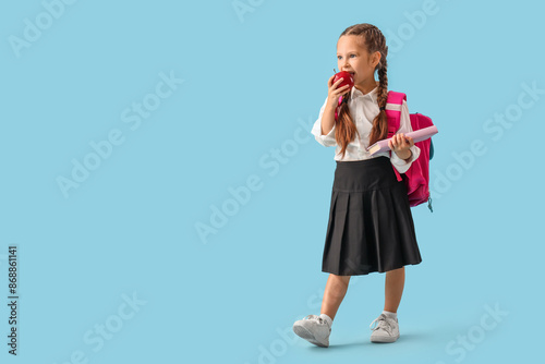 Little schoolgirl with book...