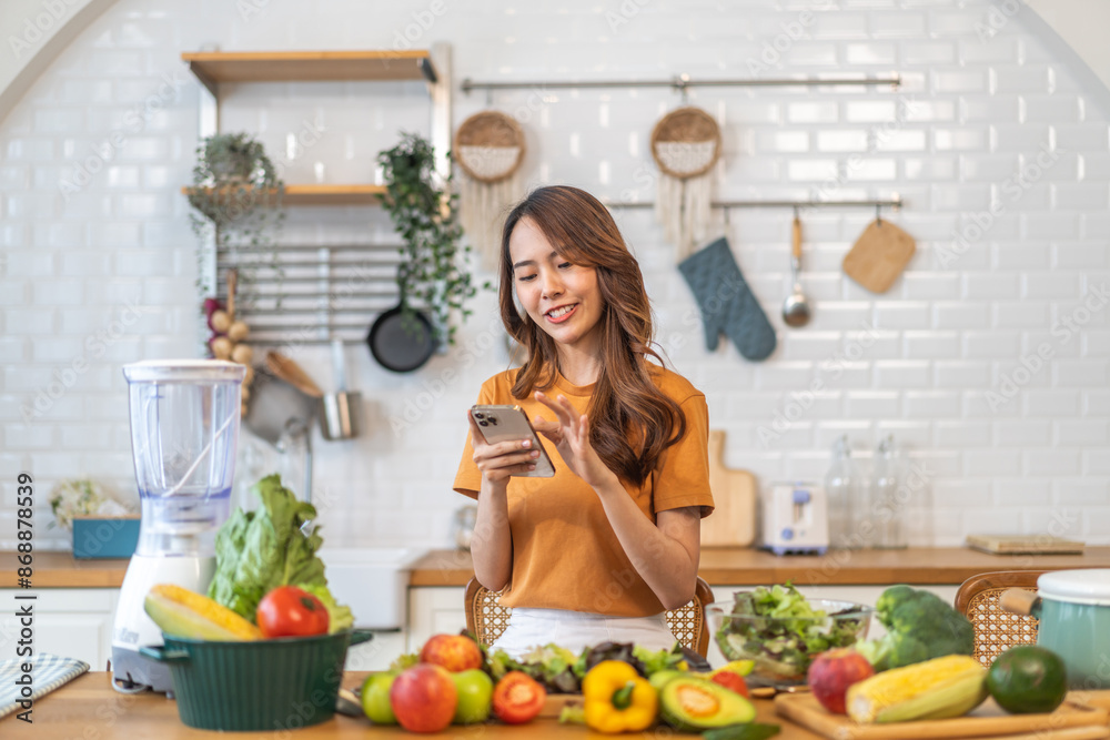 Portrait happy beauty slim healthy asian woman use phone and vegan food healthy fresh vegetable and fruit in kitchen.diet, vegetarian, eating, fruit, wellness, health, green food.Fitness, healthy food Portrait happy beauty slim healthy asian woman use phone and vegan food healthy fresh vegetable and fruit in kitchen.diet, vegetarian, eating, fruit, wellness, health, green food.Fitness, healthy food