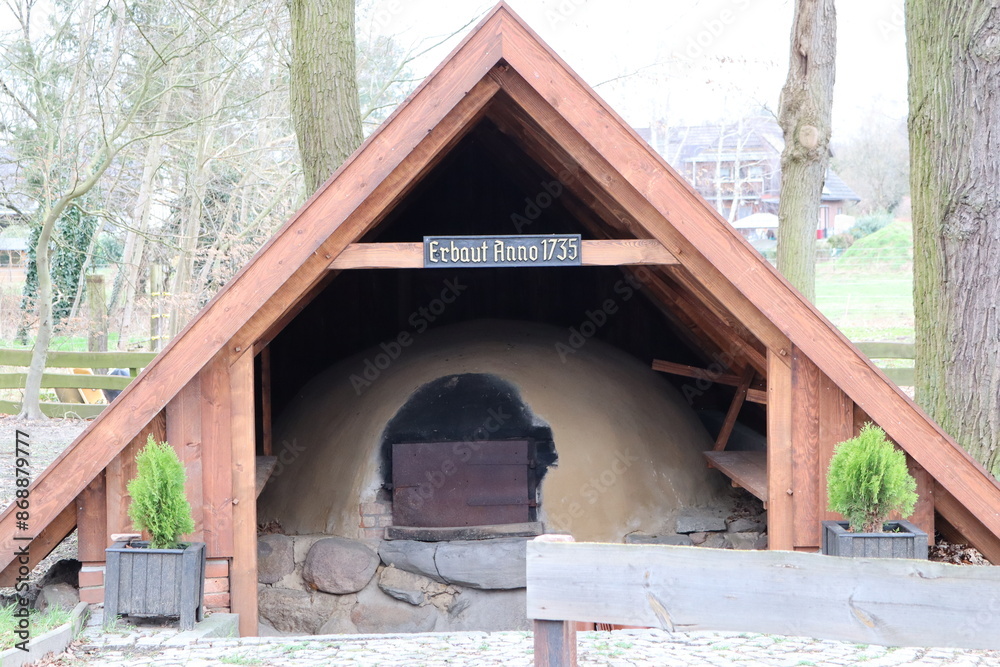 Ancient mud oven in rustic shelter blends tradition with ecofriendly construction Ancient mud oven in rustic shelter blends tradition with ecofriendly construction