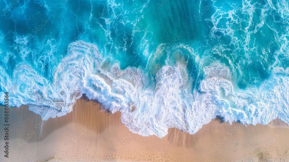 An aerial perspective of the ocean, with vivid turquoise waves crashing onto the sandy shore, showcasing the dynamic interaction between sea and land in mesmerizing patterns. An aerial perspective of the ocean, with vivid turquoise waves crashing onto the sandy shore, showcasing the dynamic interaction between sea and land in mesmerizing patterns.
