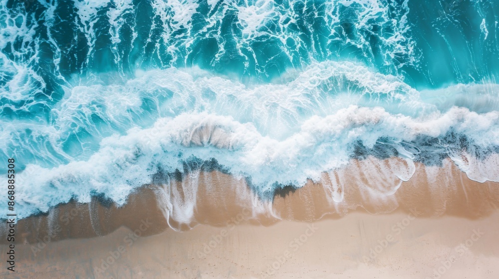 An aerial view captures the powerful waves crashing onto a sandy shore, revealing the beautiful patterns and textures created by the ocean's constant motion. An aerial view captures the powerful waves crashing onto a sandy shore, revealing the beautiful patterns and textures created by the ocean's constant motion.