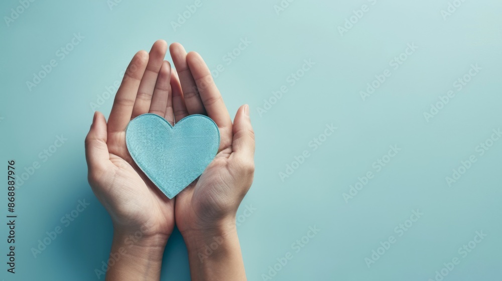 An evocative image featuring a hand holding a blue heart cutout against a light blue backdrop, capturing themes of love, warmth, and human connection in a minimalistic style. An evocative image featuring a hand holding a blue heart cutout against a light blue backdrop, capturing themes of love, warmth, and human connection in a minimalistic style.