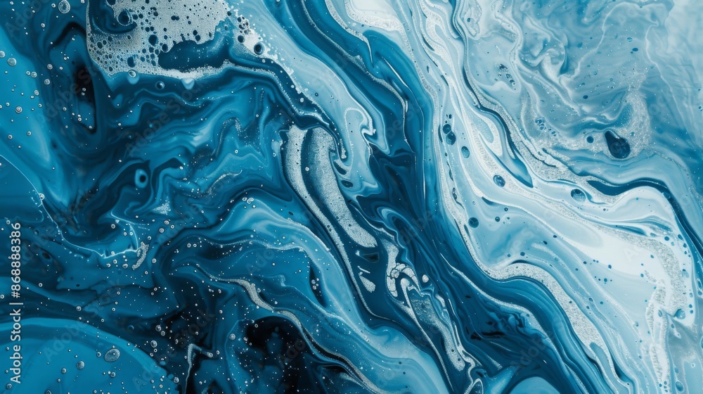 Fototapeta premium This image showcases intricate and dynamic patterns of swirling blue and white hues, resembling liquid or marbled waves, creating a captivating abstract artwork.