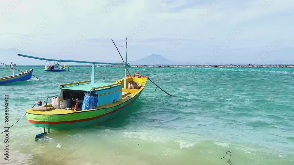 Traditional wooden fishing and passenger boats moored on the beautiful beach in Gili Ketapang, Indonesia Traditional wooden fishing and passenger boats moored on the beautiful beach in Gili Ketapang, Indonesia