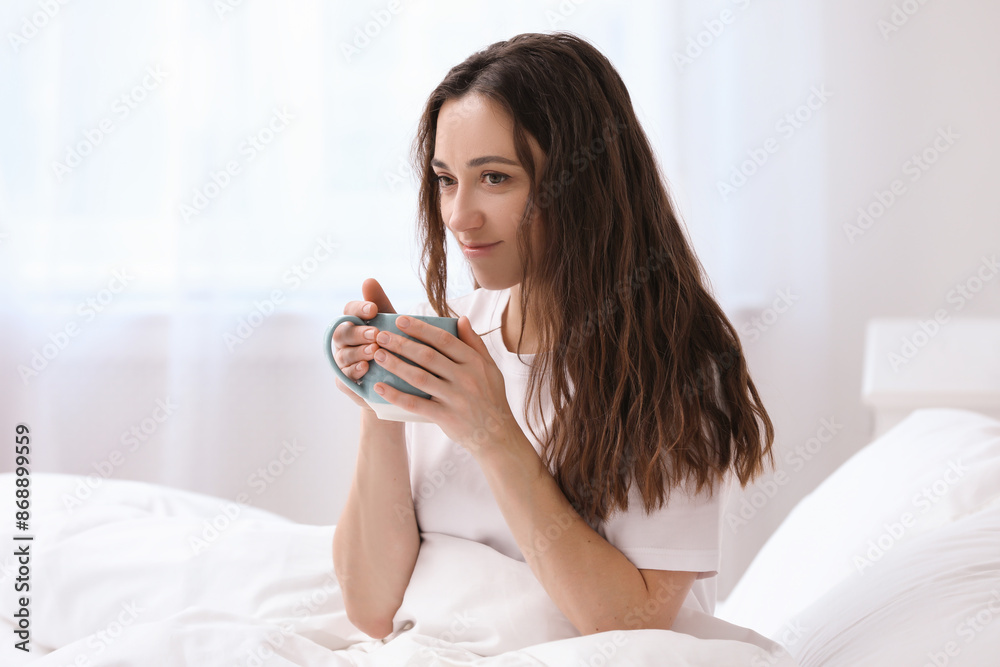 Woman drinking coffee in bed at home. Good morning Woman drinking coffee in bed at home. Good morning