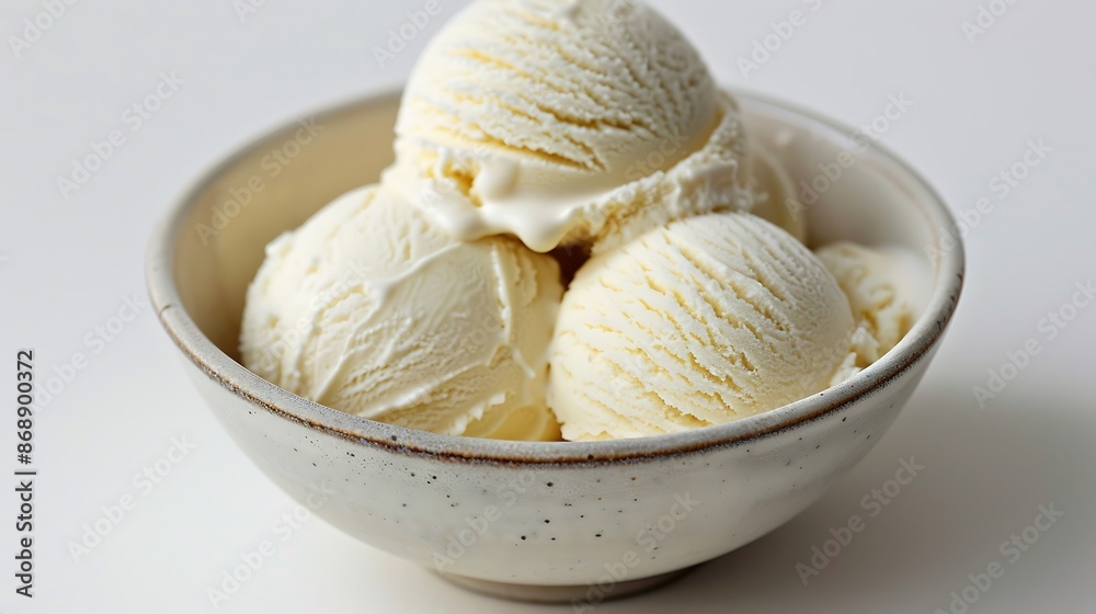 Scoops of vanilla ice cream in a bowl on a white background Scoops of vanilla ice cream in a bowl on a white background