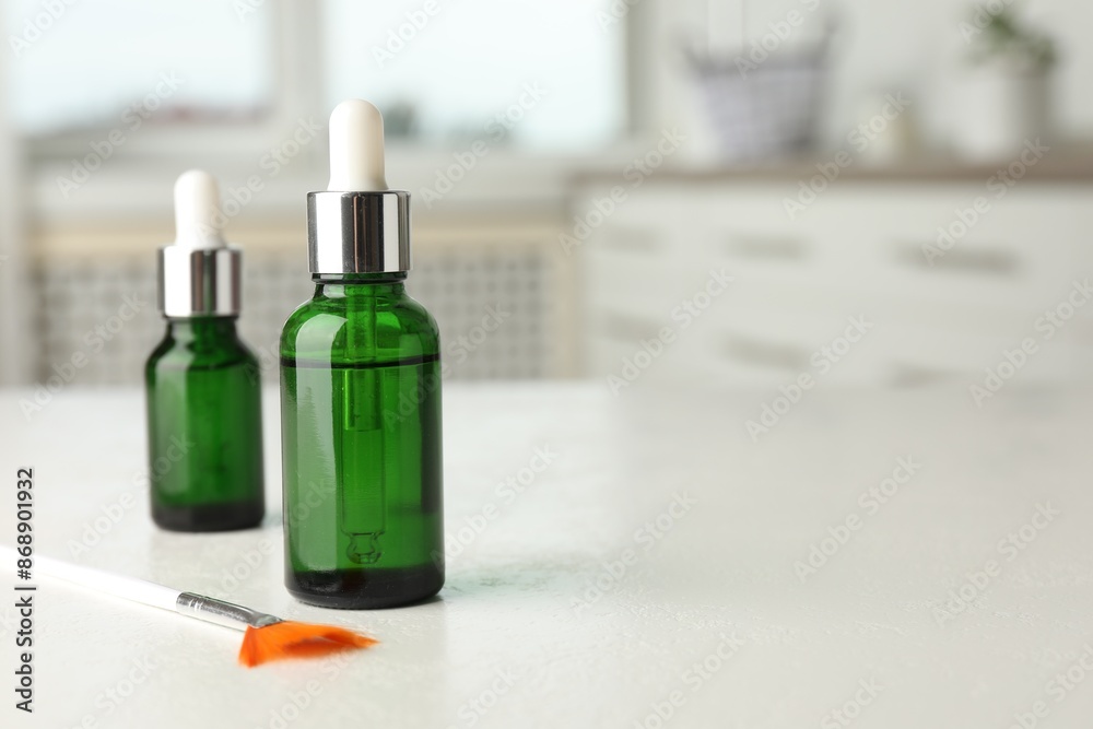 Peeling procedure. Bottles of chemical peel and brush on white table indoors. Space for text Peeling procedure. Bottles of chemical peel and brush on white table indoors. Space for text
