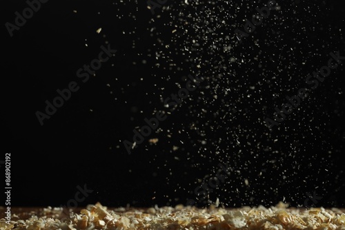 Photos Dry natural sawdust falling on black background