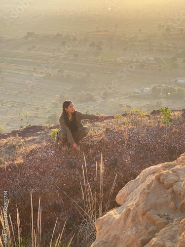 Young Mexican Girl with triumph pose in the top of a mountain in San Jerónimo Tecuanipan, Puebla, Mexico