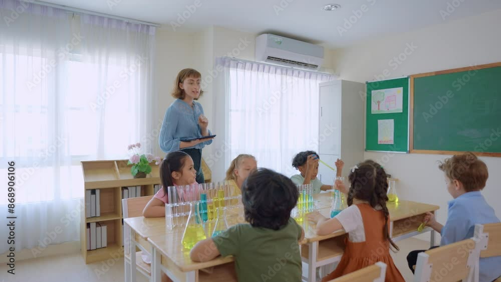 Adorable student learn with teacher in classroom at elementary school. Adorable student learn with teacher in classroom at elementary school.