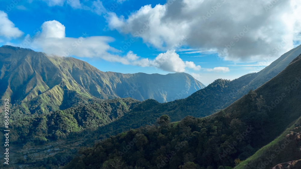 Fototapeta premium green hills, peaks of Pergasingan hills around Mount Rinjani. its landscape for hiking and outdoor lifestyle concept. beautiful natural scenery