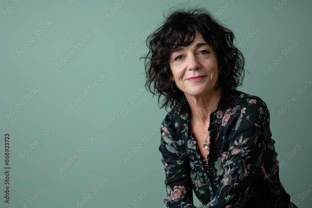 Portrait of a beautiful middle-aged woman on a green background Portrait of a beautiful middle-aged woman on a green background