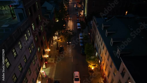 Rising top down shot of traffic scene at night in american town. Lighting lantern and shop illumination in USA. photo
