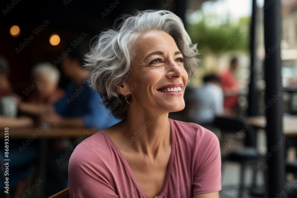 Portrait of happy senior woman in cafe. Mature woman smiling and looking away. Portrait of happy senior woman in cafe. Mature woman smiling and looking away.