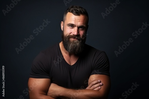 Portrait of a handsome man with long beard and mustache on dark background © Stocknterias