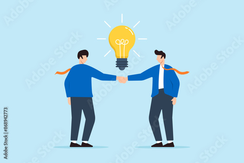 Two businessman handshake with glowing light bulb concept innovation collaboration and creative partnerships