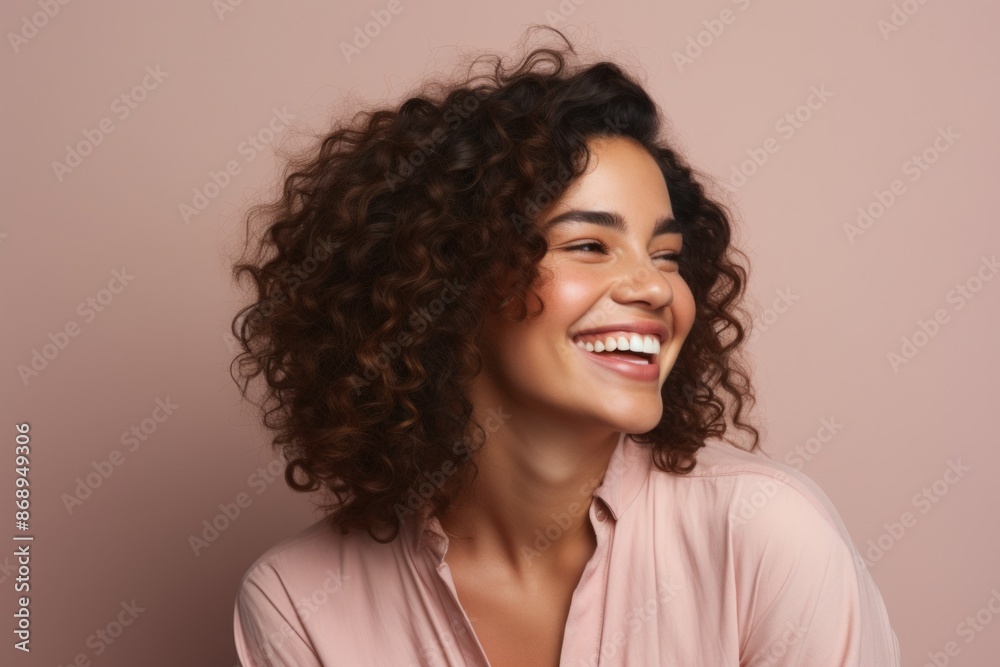 Portrait of a beautiful young woman with curly hair smiling at camera Portrait of a beautiful young woman with curly hair smiling at camera