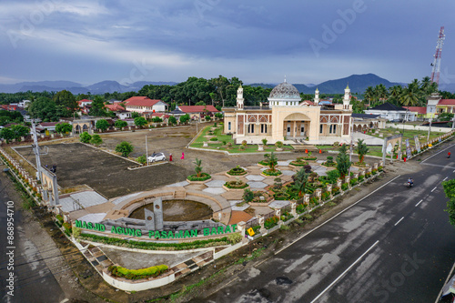 Masjid Raya Pasaman Barat, mosque with a beautiful mountain backdrop and clear skies in the afternoon photo