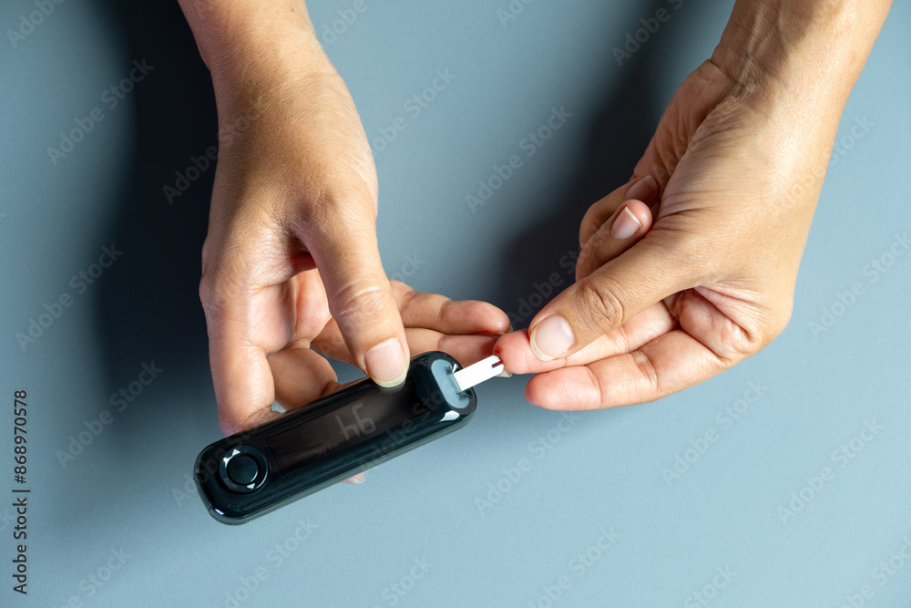 Woman's hands checking diabetes and hyperglycemia with digital blood sugar meter. Healthcare and medical concept
Woman's hands checking diabetes and hyperglycemia with digital blood sugar meter. Healthcare and medical concept