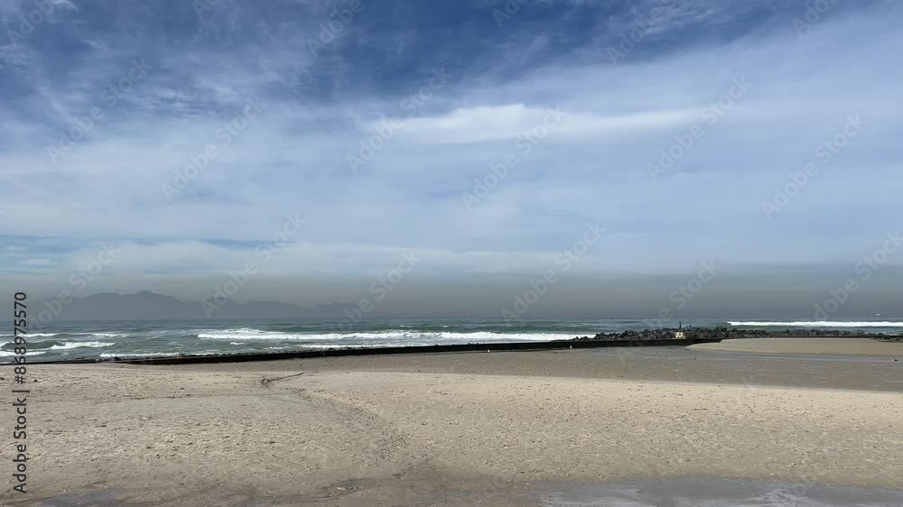 Tidal pool being cleaned with rolling waves white surf by the beach Tidal pool being cleaned with rolling waves white surf by the beach