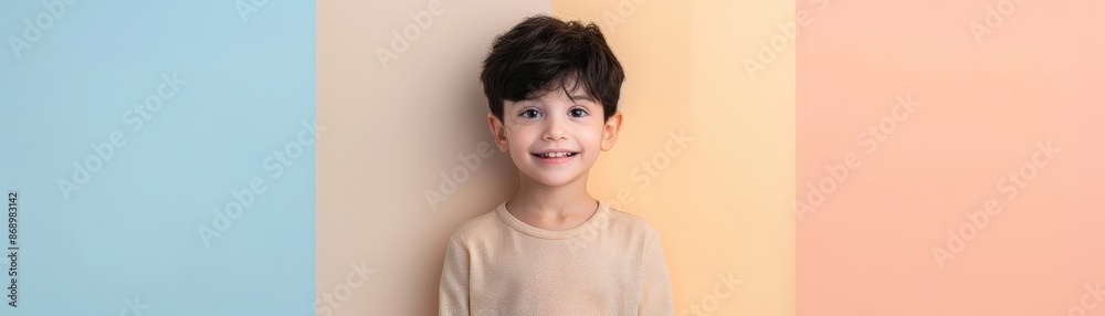 Smiling boy with dark hair in front of colorful background. Smiling boy with dark hair in front of colorful background.