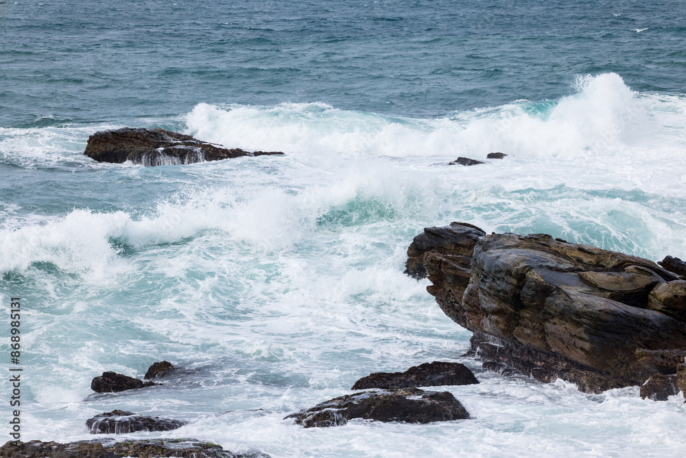 Sea ocean wave over the rocky stone