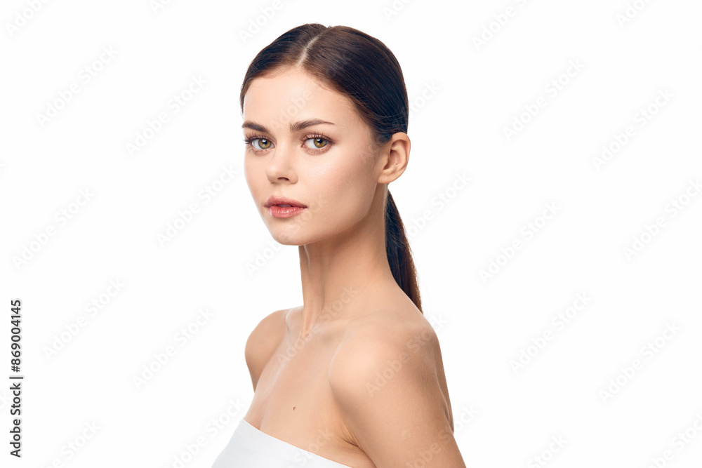 Woman in white towel posing with eyes closed and hair in ponytail, isolated on white background Woman in white towel posing with eyes closed and hair in ponytail, isolated on white background