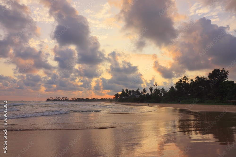 Empty tropical beach with ocean and palms at sunset Empty tropical beach with ocean and palms at sunset