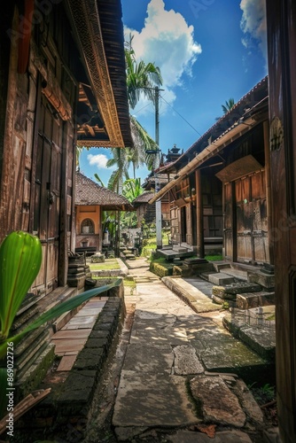 Narrow alley between buildings with palm tree