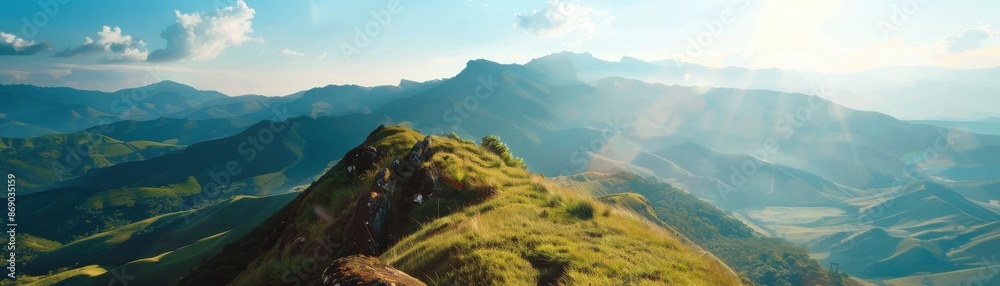 Breathtaking view from a mountain peak, bathed in sunlight and surrounded by lush valleys and distant hills under a clear blue sky. Breathtaking view from a mountain peak, bathed in sunlight and surrounded by lush valleys and distant hills under a clear blue sky.