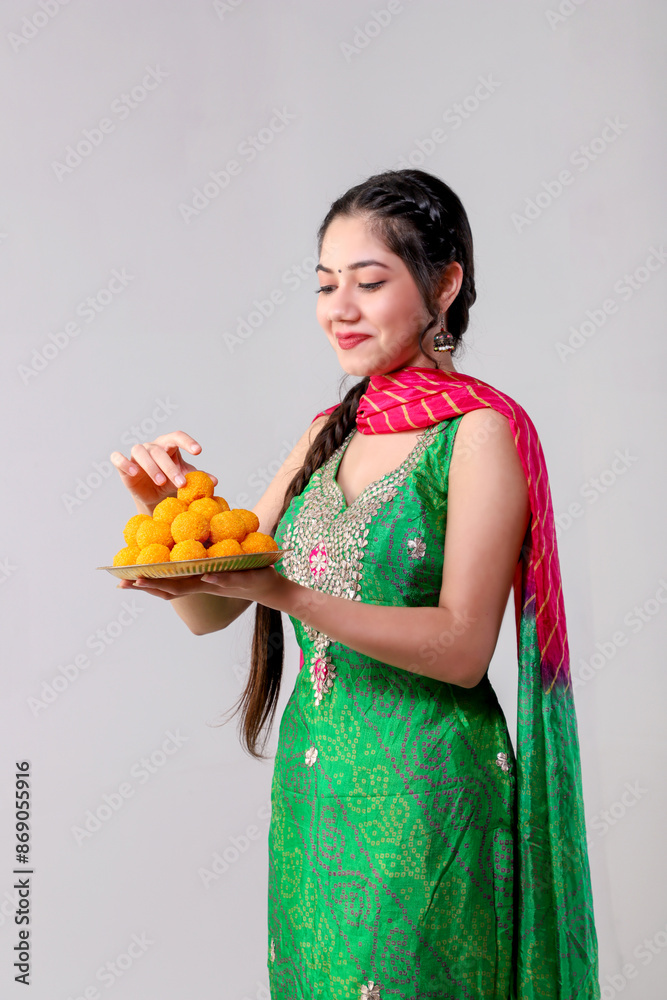 Gorgeous Model In Punjabi Suit Smiling With A Plate Full Of Laddus In Her Hand Gorgeous Model In Punjabi Suit Smiling With A Plate Full Of Laddus In Her Hand