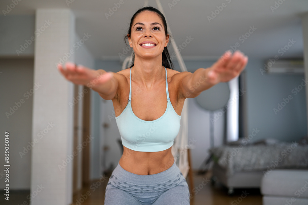 Fit young woman doing exercise, workout at home, training in living room to stay healthy Fit young woman doing exercise, workout at home, training in living room to stay healthy